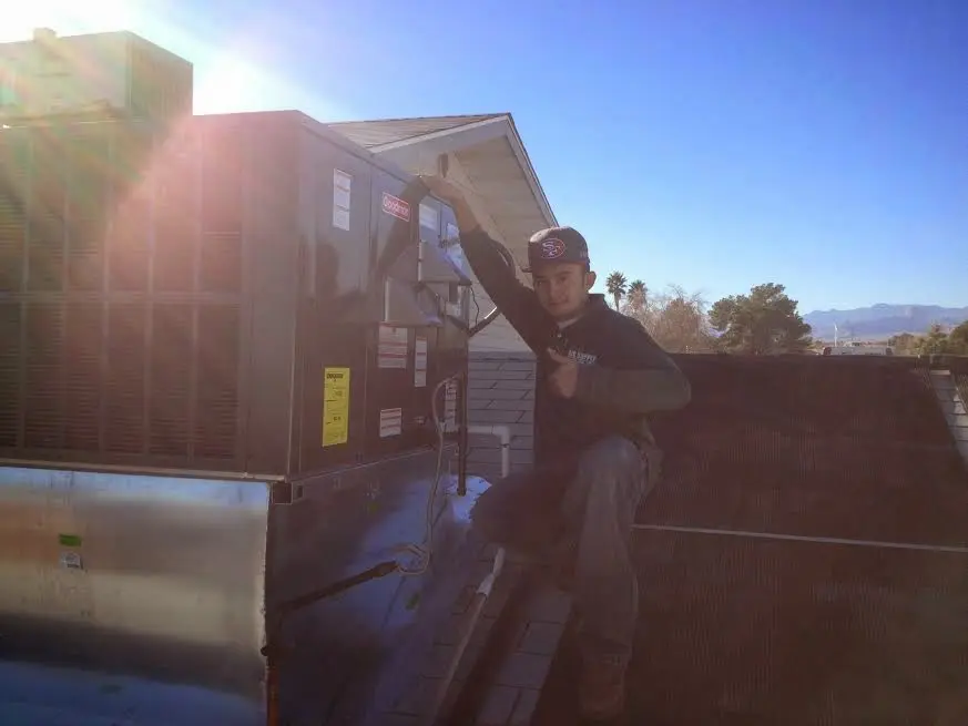 HVAC technician performing Heat Pump Repair on a rooftop unit in Santa Clara